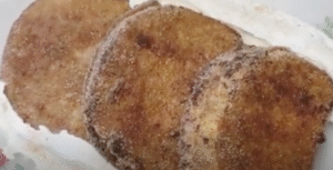 torrijas de chocolate servidas en una bandeja y acompañados de nata montada
