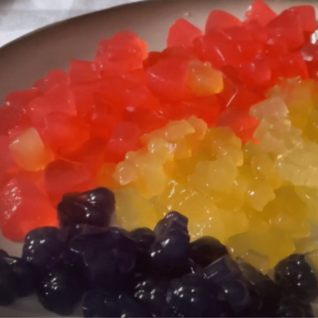 plato con gominolas caseras moradas, amarillas y naranjas