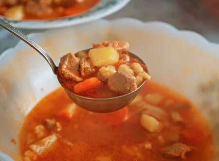 cazo tomando un poco de estofado de la olla