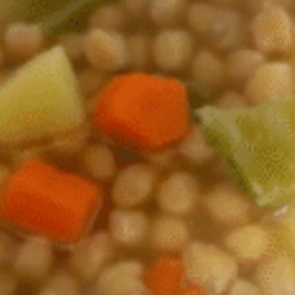 detalle de plato servido con cocido andaluz con garbanzos, caldo, patata y verduras