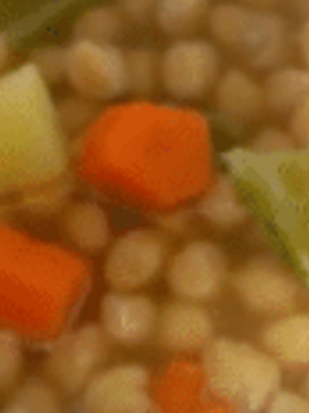 detalle de plato servido con cocido andaluz con garbanzos, caldo, patata y verduras